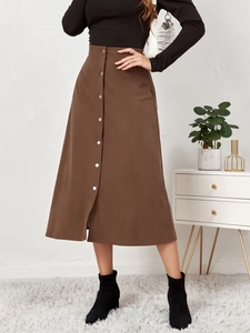 Close-up of brown corduroy midi skirt with high waist and single-breasted button detail