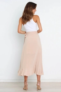 Rear view of an apricot wrap midi skirt with ruffle hem and side bow tie detail