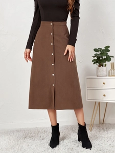 Detail view of coffee corduroy skirt featuring a high-waist A-line cut and silver buttons