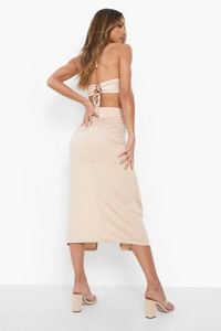 Detailed back view of beige lace-up halter top and matching slim fit midi skirt