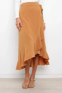 Detailed view of ginger yellow wrap skirt with elegant ruffle trim and asymmetrical hemline