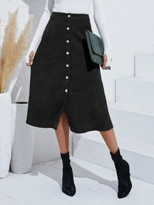 Detail of black corduroy A-line skirt with silver buttons and vertical texture
