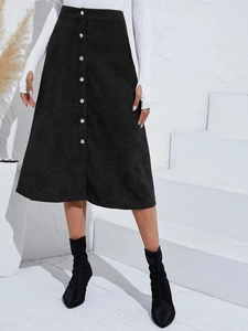 Detailed close-up of corduroy texture and silver buttons on a black A-line skirt