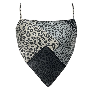 Detail of leopard print crop top featuring thin straps and bandana style triangle hemline