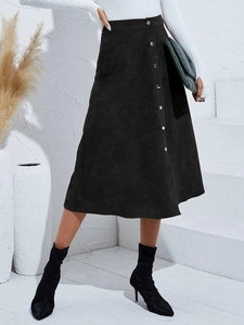 Detailed texture of black corduroy skirt with single-breasted silver buttons and A-line cut