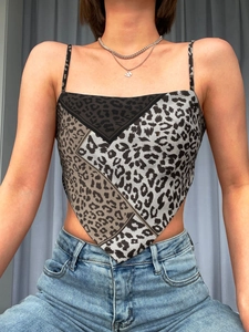 Detail view of the triangular bandana top featuring multi-patterned leopard print patchwork