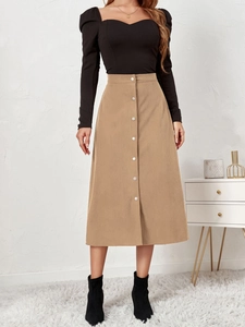 Close-up of khaki corduroy midi skirt with single-breasted buttons and A-line silhouette