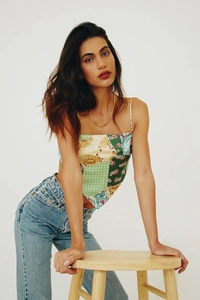 Detail of satin paisley print crop top with thin straps and scarf hem design