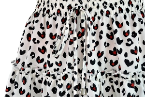 Detail of high waist floral skirt featuring heart leopard print and ruffled hem with drawstring