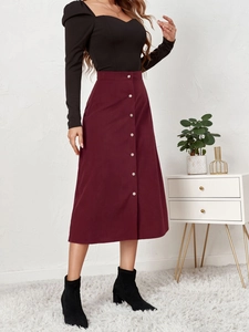Detailed close-up of wine red corduroy A-line midi skirt with stylish single-breasted buttons