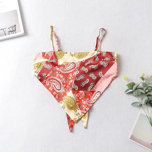 Detail of bandana style crop top with red paisley and polka dot print on silk fabric