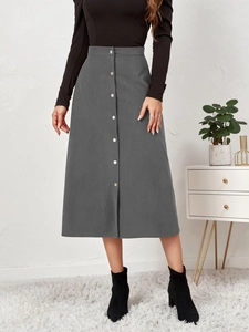 Detail of high waist grey corduroy midi skirt with metallic buttons and ribbed texture