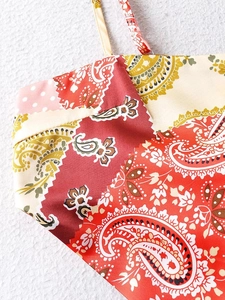Detail showing the thin straps and mixed paisley and polka dot prints on a camisole top