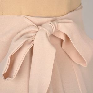 Pale pink high waist chiffon wrap skirt featuring an elegant large bow tie closure