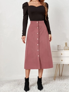 Detail of high waist corduroy skirt with single-breasted buttons and A-line texture
