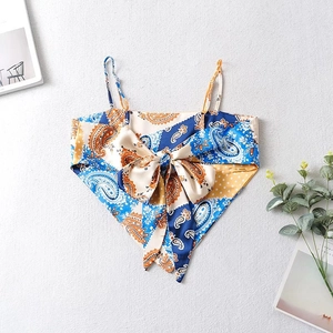 Detailed view of bohemian paisley print camisole with large bow knot and silky texture