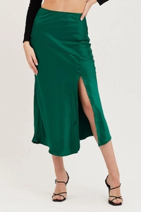 Detailed view of dark green high-waisted satin skirt featuring a stylish side slit design