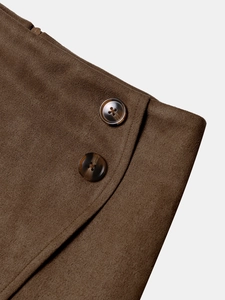 Close-up of brown suede skirt waist featuring amber resin buttons and side zipper