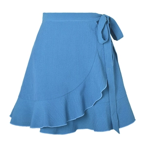 Detail of high-waisted wrap skirt fabric showing light texture and layered ruffle hem
