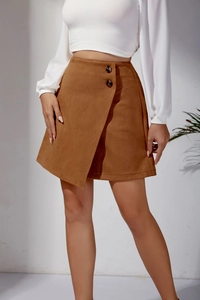Detail view of brown faux suede mini skirt with asymmetric wrap design and decorative buttons