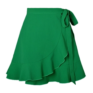 Detail of green wrap skirt showing textured fabric and delicate ruffle hemline
