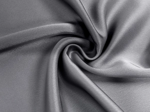 Macro shot of dark grey satin fabric showing high gloss texture and elegant drape