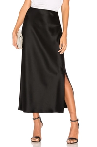 Detail view of the elegant black satin skirt featuring a stylish side slit and glossy finish
