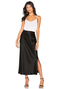 Detail of high-waist black satin midi skirt with elegant side slit and glossy finish