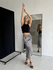 Dettaglio della gonna midi in raso con stampa leopardata ed elegante drappeggio