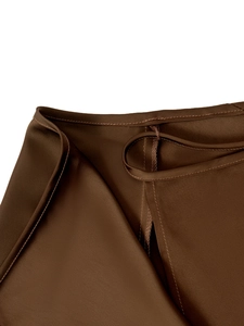 Detail shot of dark brown satin skirt waist showing fine stitching and hemline finish