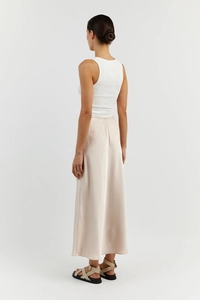 Back view of a champagne satin maxi skirt paired with a white ribbed tank top