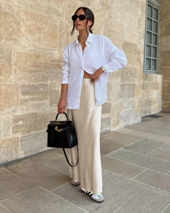 Elegant champagne satin maxi skirt paired with a white linen shirt in a street style look