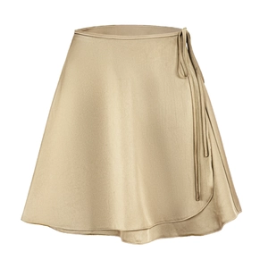 Detailed macro view of champagne gold satin wrap skirt texture and fine stitching lines