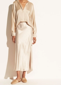 Detail view of champagne satin fabric texture on high waist side slit midi skirt