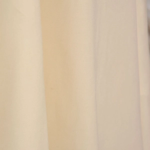 Macro view of light beige twill fabric texture with elegant vertical drapes and soft lines