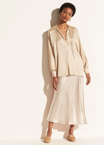 Close-up of elegant champagne satin midi skirt with premium silk texture and fine stitching