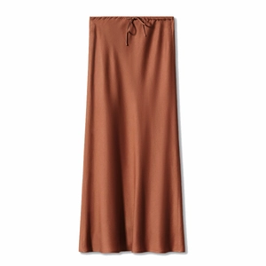 Detail of high-waisted satin maxi skirt featuring adjustable drawstring waist and silk texture