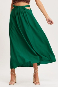 Detail of emerald green high-waisted maxi skirt with side cutout and elastic pleated waist