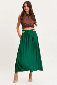 Detail showing the side cut-out high waist design on a dark green maxi skirt