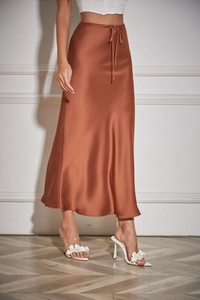 Detailed close-up of a premium rust satin midi skirt with high-waist drawstring ties