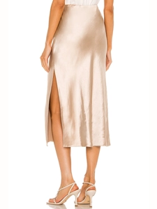 Detail view of champagne satin midi skirt featuring a high waist and elegant side slit