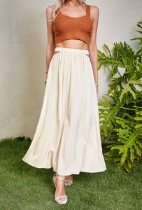 Detail view of high waist cream maxi skirt with side cutout and elastic waistband texture