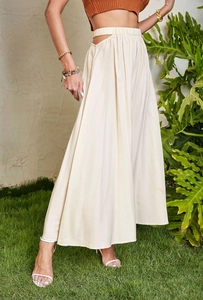 Detail view showing side cutout design and elastic high waist of this beige maxi skirt