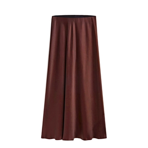 Detail of high waist elastic band and deep brown satin fabric on the maxi skirt