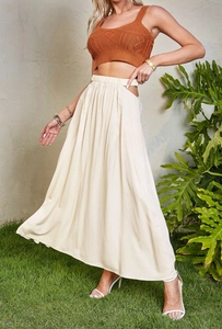Detail of high waisted cream maxi skirt with side cutout and elastic waistband