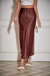 Close-up of brown satin midi skirt texture with high-waisted drawstring and silk finish
