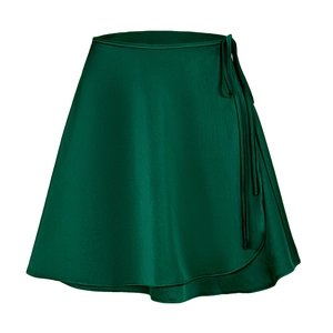 Detailed close-up of dark green satin wrap skirt featuring a stylish side tie waist knot