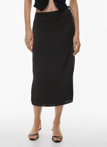 Detail of the side tie design on a sleek high-waisted black satin midi skirt