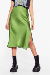 Detail of moss green acetate satin midi skirt featuring a high side slit and silky texture