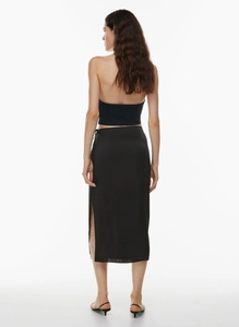 Rear view of sleek black satin midi skirt with side slit and matching halter top